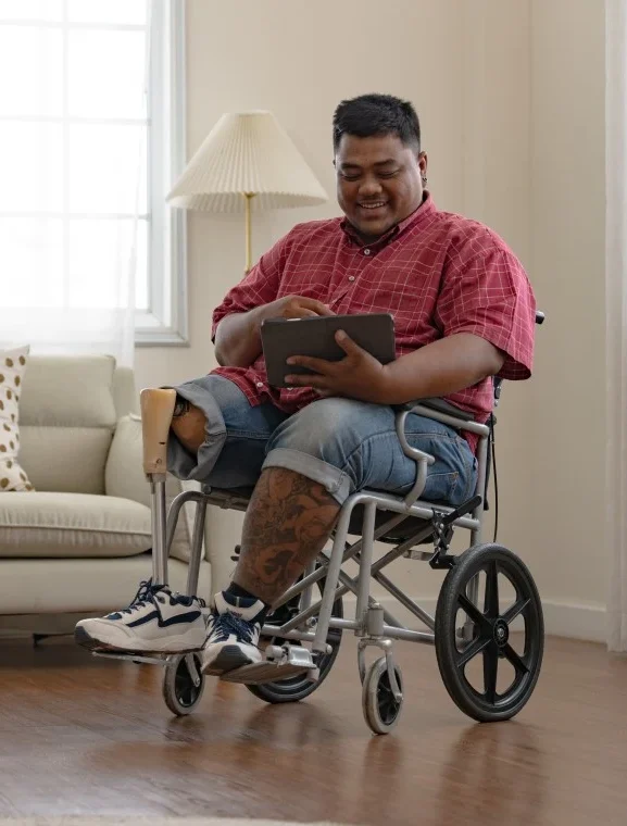 Disabled man in wheelchair using iPad to look up DuraCare